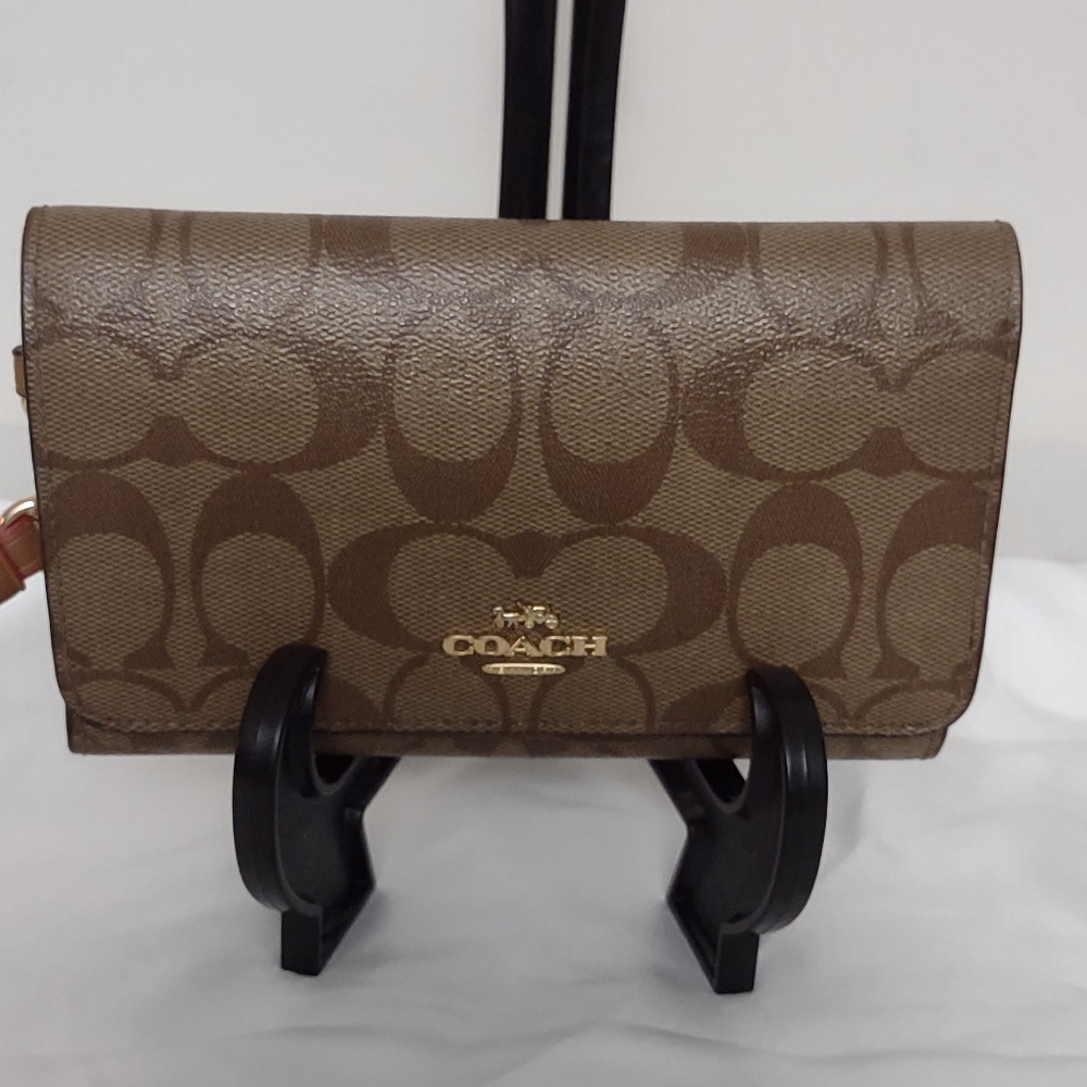 Beautiful coach signature wallet with bright pink accent color!
